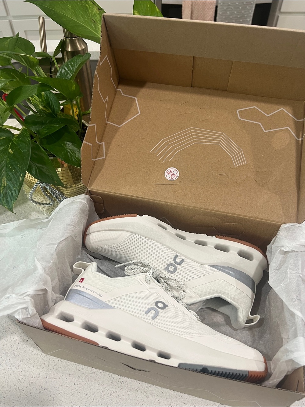 On Running sneakers in White with Orange and Gray Outsole Accents